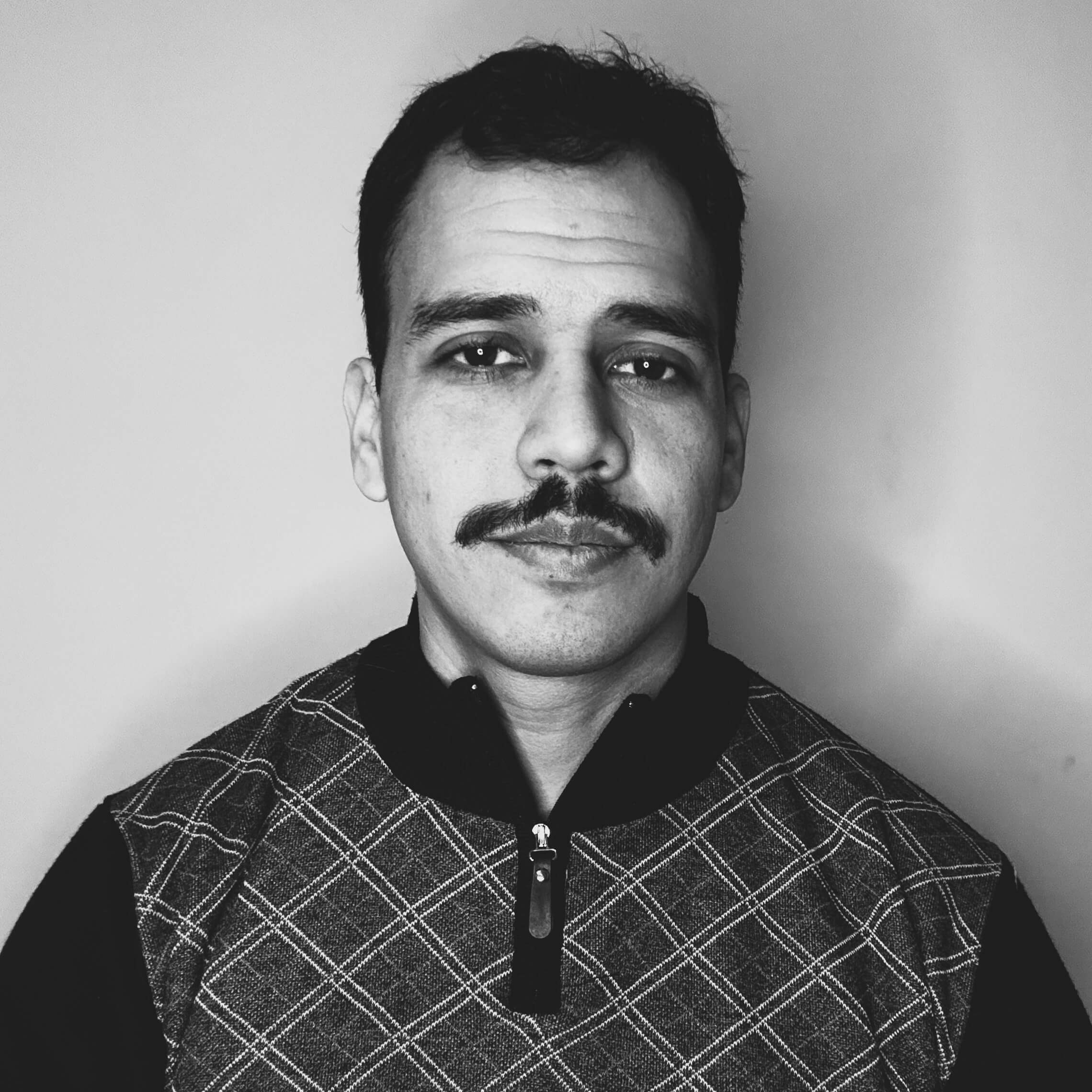 Juan Madrigal in professional attire.