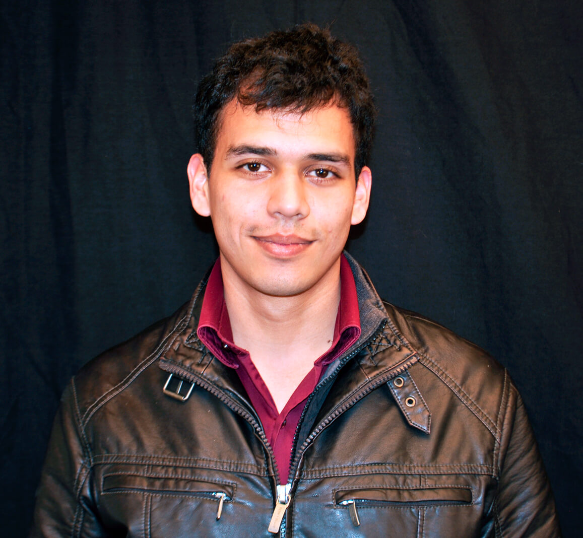 Juan Madrigal in professional attire.